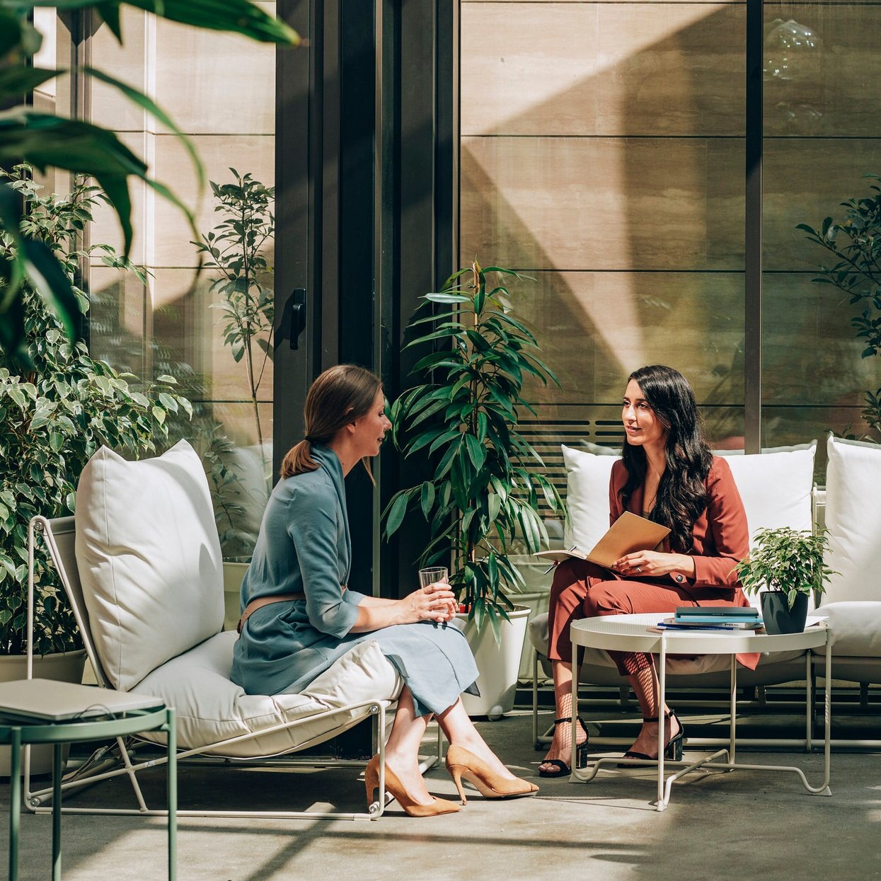 Two women talking on a patio – online psychiatry in Long Beach, CA